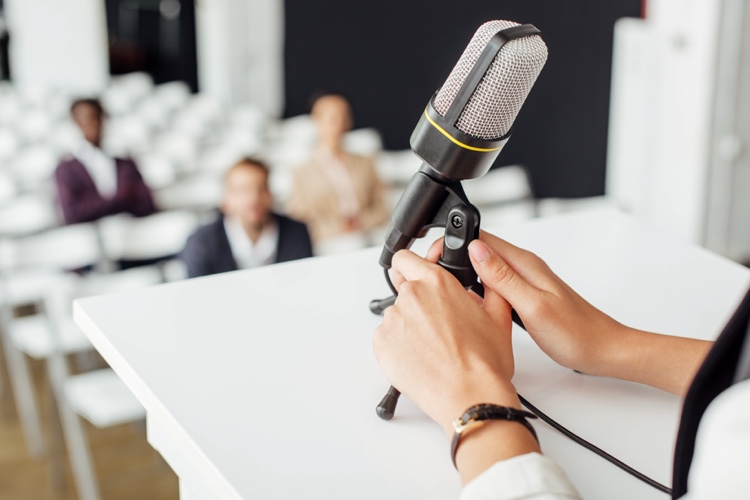 podium, speaker and microphone with audience